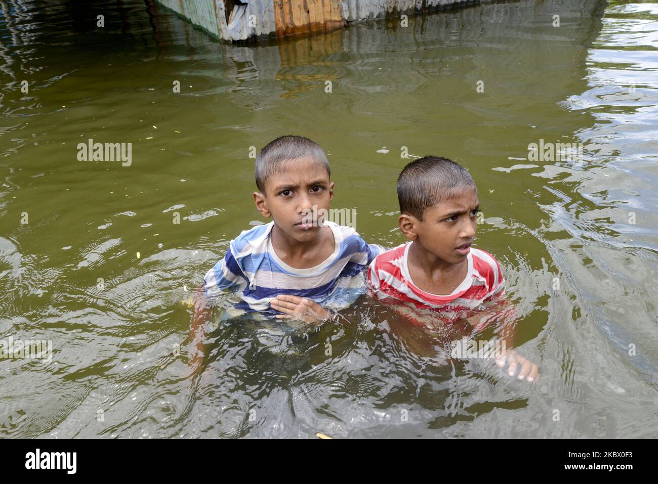 Villager children walk in flood water in Savar near Dhaka, Bangladesh ...