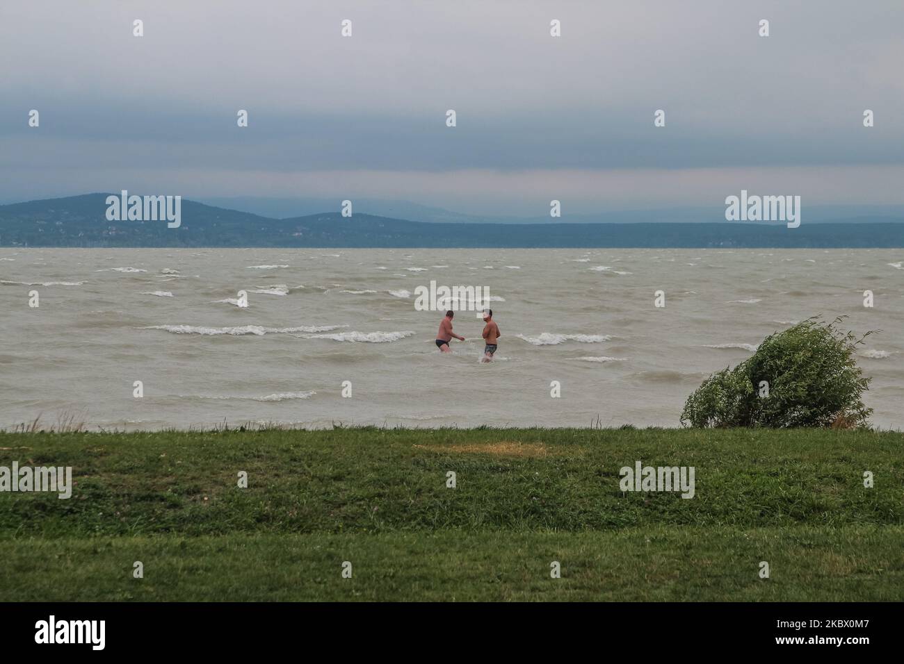 People taking a bath during stormy weather and high waves on the Balaton  lake at a dog friendly beach is seen in Fonyod, Hungary, on 5 August 2020  (Photo by Michal Fludra/NurPhoto