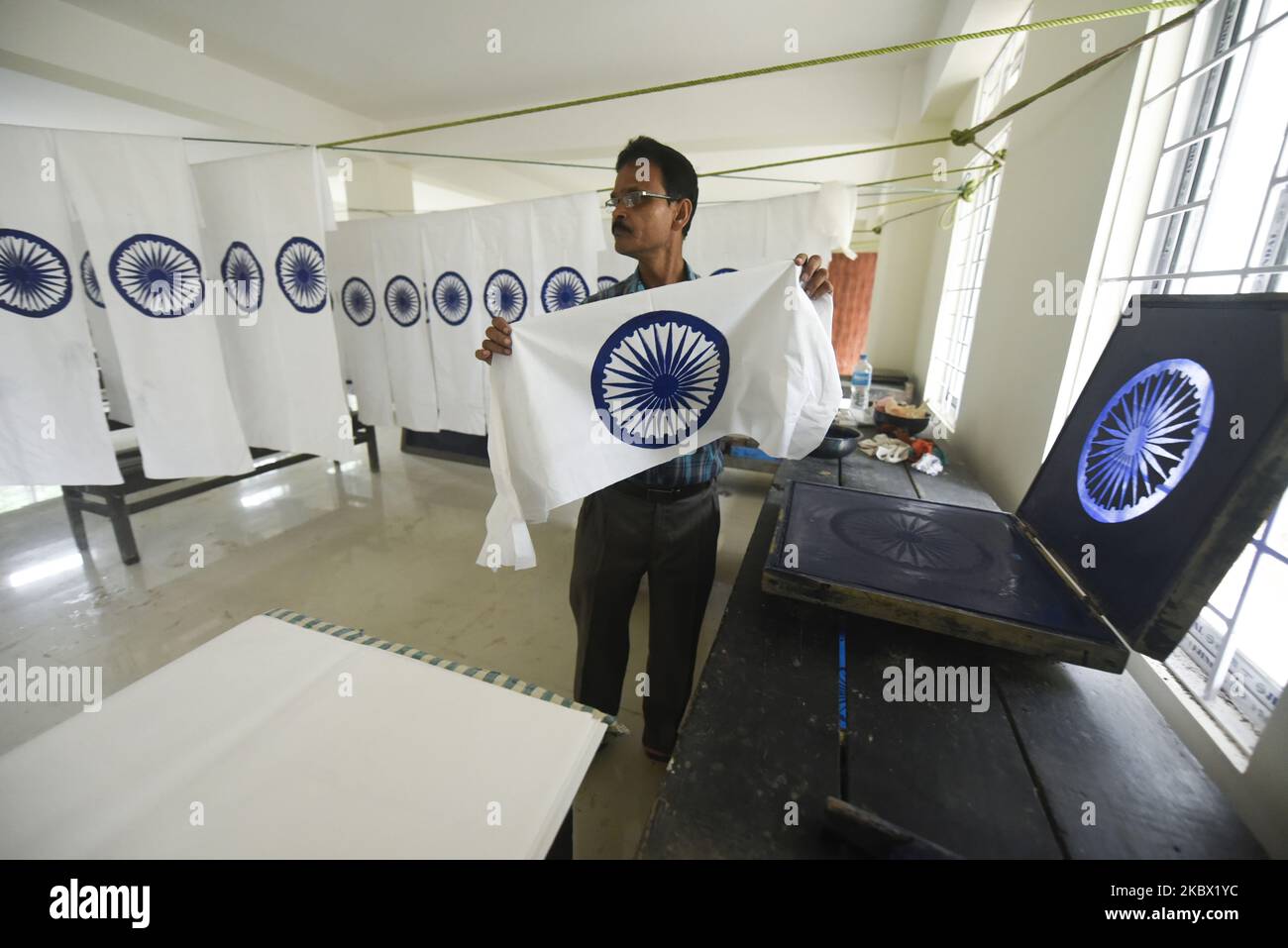 An employee of Assam Khadi and Village Industries Board prints Ashoka Chakra on the Indian flag or tricolor as part of preparations ahead of Independence Day, in Guwahati, Assam, India on Tuesday, 11 August 2020. (Photo by David Talukdar/NurPhoto) Stock Photo