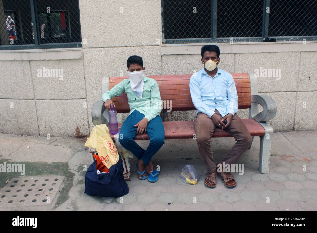A father with his child waits for result after giving a swab sample for Rapid Antigen Test (RAT) for the COVID-19 coronavirus at Chacha Nehru Bal Chikitsalaya near Geeta Colony in New Delhi on August 11, 2020. For the past seven days, India's single-day count of Covid-19 cases has been more than that of the US and Brazil, the two worst-hit nations in terms of infections, according to an analysis of WHO data. India, the third worst-hit nation in terms of infections, has also accounted for over 23 per cent of the cases and more than 15 per cent of the deaths reported worldwide between August 4-1 Stock Photo