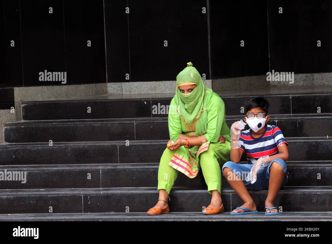 A mother with her child waits for result after giving a swab sample for Rapid Antigen Test (RAT) for the COVID-19 coronavirus at Chacha Nehru Bal Chikitsalaya near Geeta Colony in New Delhi on August 11, 2020. For the past seven days, India's single-day count of Covid-19 cases has been more than that of the US and Brazil, the two worst-hit nations in terms of infections, according to an analysis of WHO data. India, the third worst-hit nation in terms of infections, has also accounted for over 23 per cent of the cases and more than 15 per cent of the deaths reported worldwide between August 4-1 Stock Photo