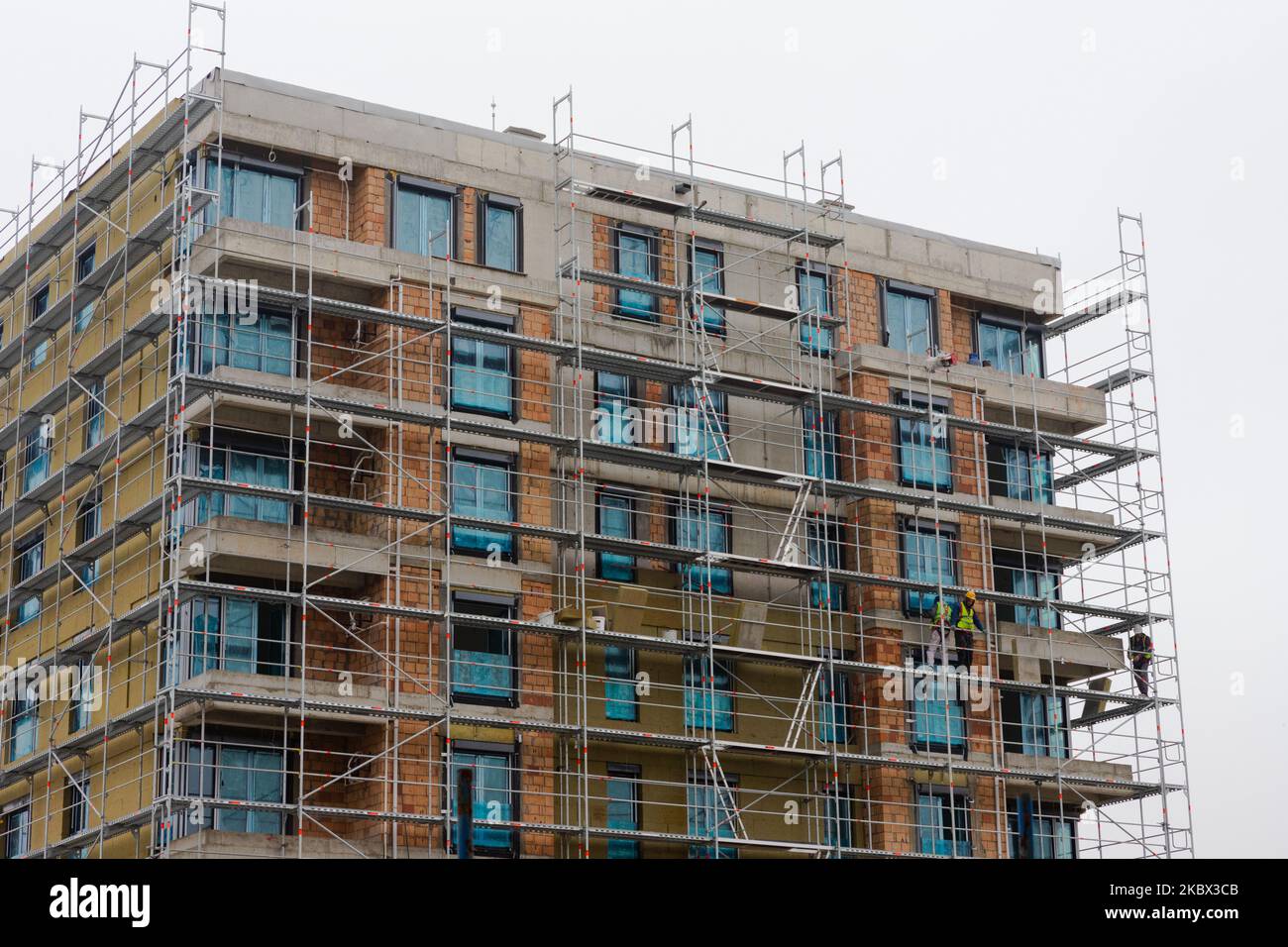 Building apartment building. Placing rock wool insulation on the walls ...