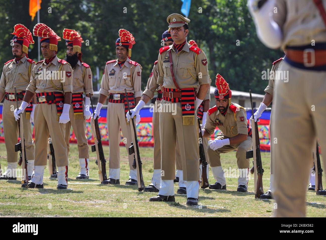 A Jammu and Kashmir Police personnel takes rest during the parade on