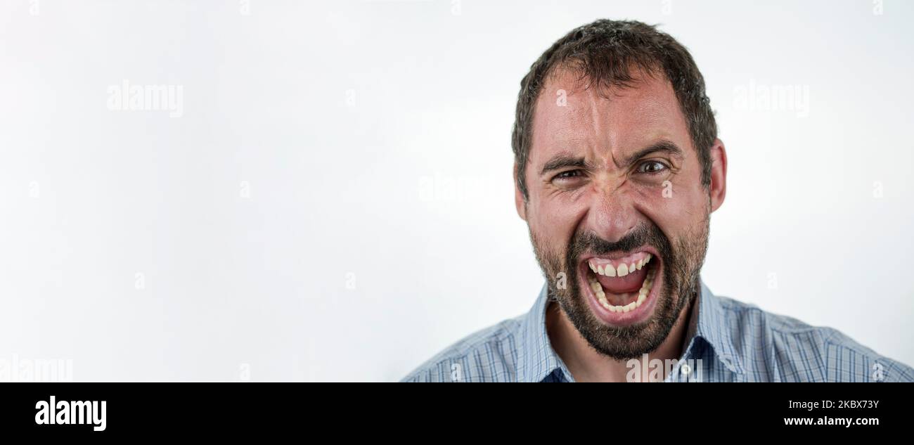 Portrait of angry insane man screaming isolated on white background Stock Photo