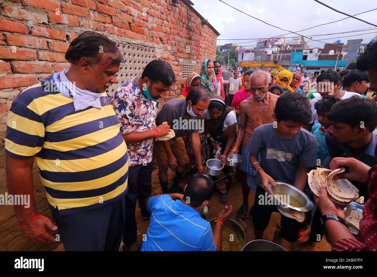 Rashtriya Sawam Sangh (RSS) members distribute food at landslide affected areas after the following heavy rainfall at Sundar Nagar Ganesh Vihar colony,Lal Dungari , in Jaipur, Rajasthan, India, Aug 16,2020.(Photo by Vishal Bhatnagar/NurPhoto) Stock Photo