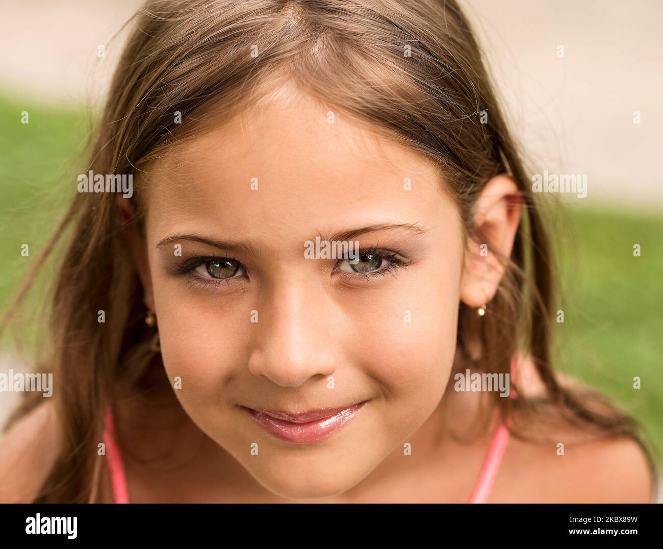 Portrait of a cute happy girl with blue eyes and a beautiful smile Stock Photo