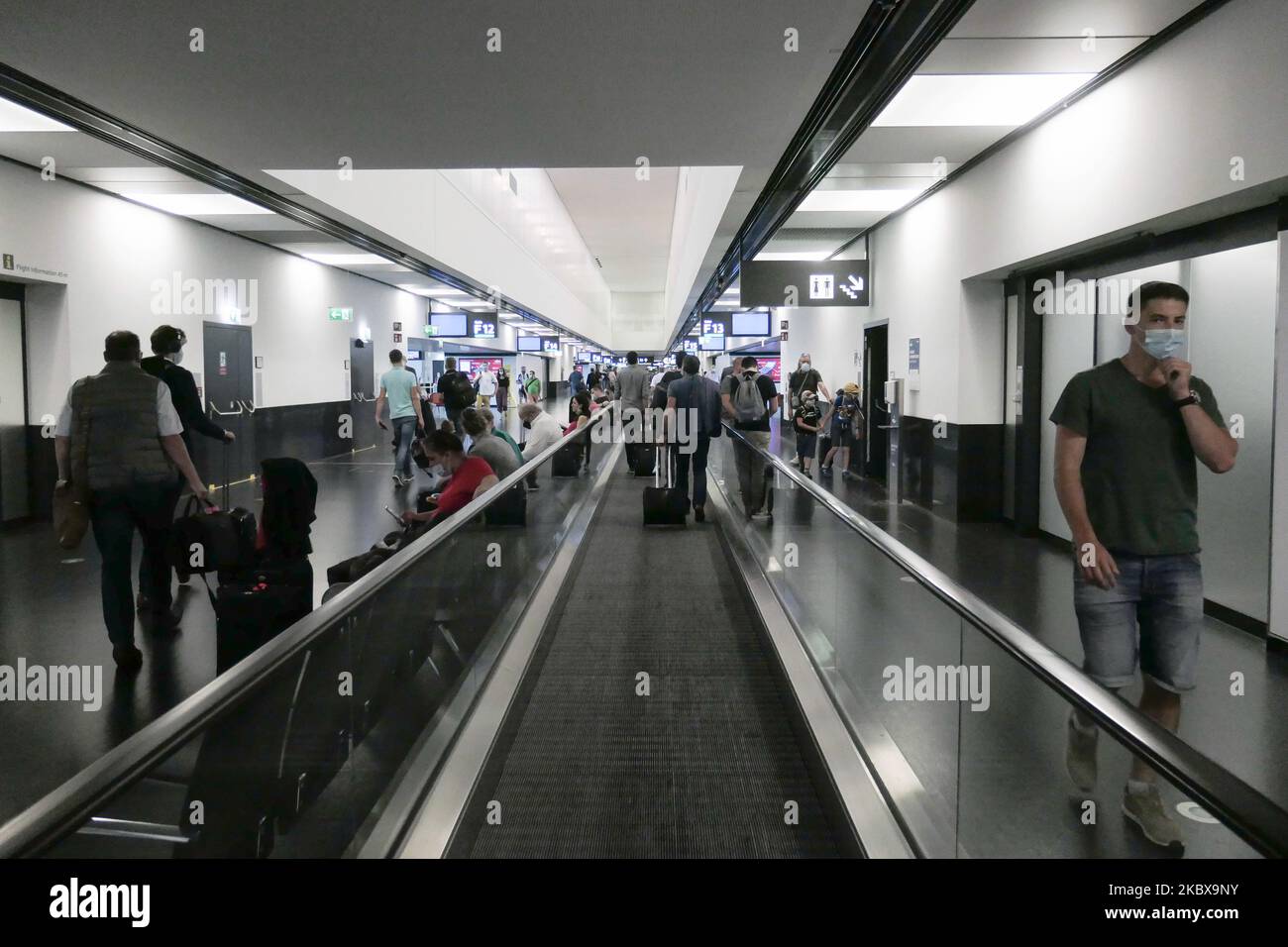 Passengers wearing facemasks, gloves and safety measures are seen at the terminal, F Gates area of Vienna International Airport VIE LOWW - Flughafen Wien-Schwechat, on July 15, 2020 serving the Austrian Capital but also Bratislava as it is 55km away from the Slovak city during the Covid-19 Coronavirus pandemic era with social distancing measures and disinfecting hand sanitizer everywhere afther the lockdown period. On July 1, Austria issues travel warning for six Balkan states countries, Serbia, Montenegro, Bosnia Herzegovina, North Macedonia, Albania and Kosovo. Passengers traveling from thos Stock Photo