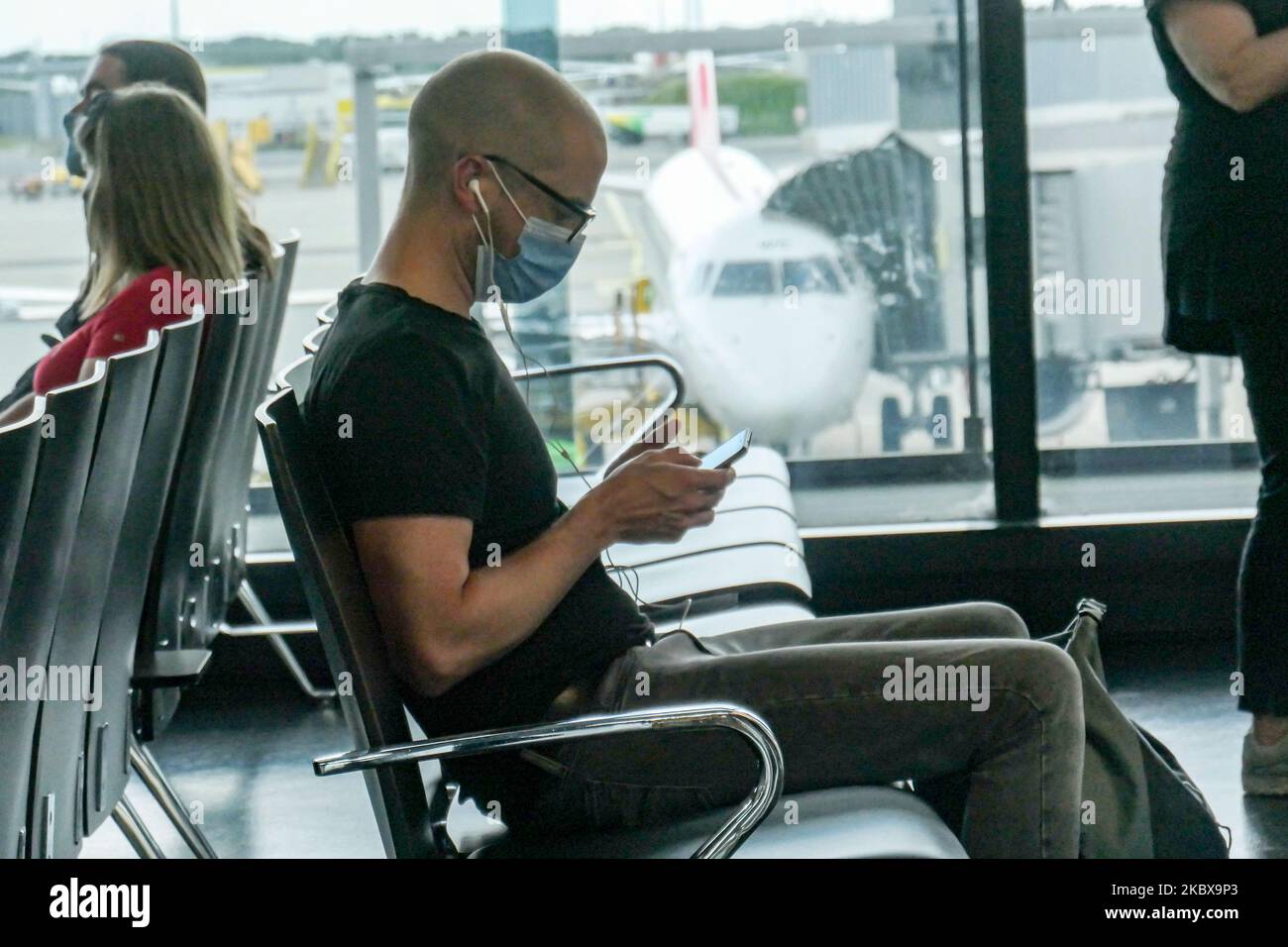 Passengers wearing facemasks, gloves and safety measures are seen at the terminal, F Gates area of Vienna International Airport VIE LOWW - Flughafen Wien-Schwechat, on July 15, 2020 serving the Austrian Capital but also Bratislava as it is 55km away from the Slovak city during the Covid-19 Coronavirus pandemic era with social distancing measures and disinfecting hand sanitizer everywhere afther the lockdown period. On July 1, Austria issues travel warning for six Balkan states countries, Serbia, Montenegro, Bosnia Herzegovina, North Macedonia, Albania and Kosovo. Passengers traveling from thos Stock Photo