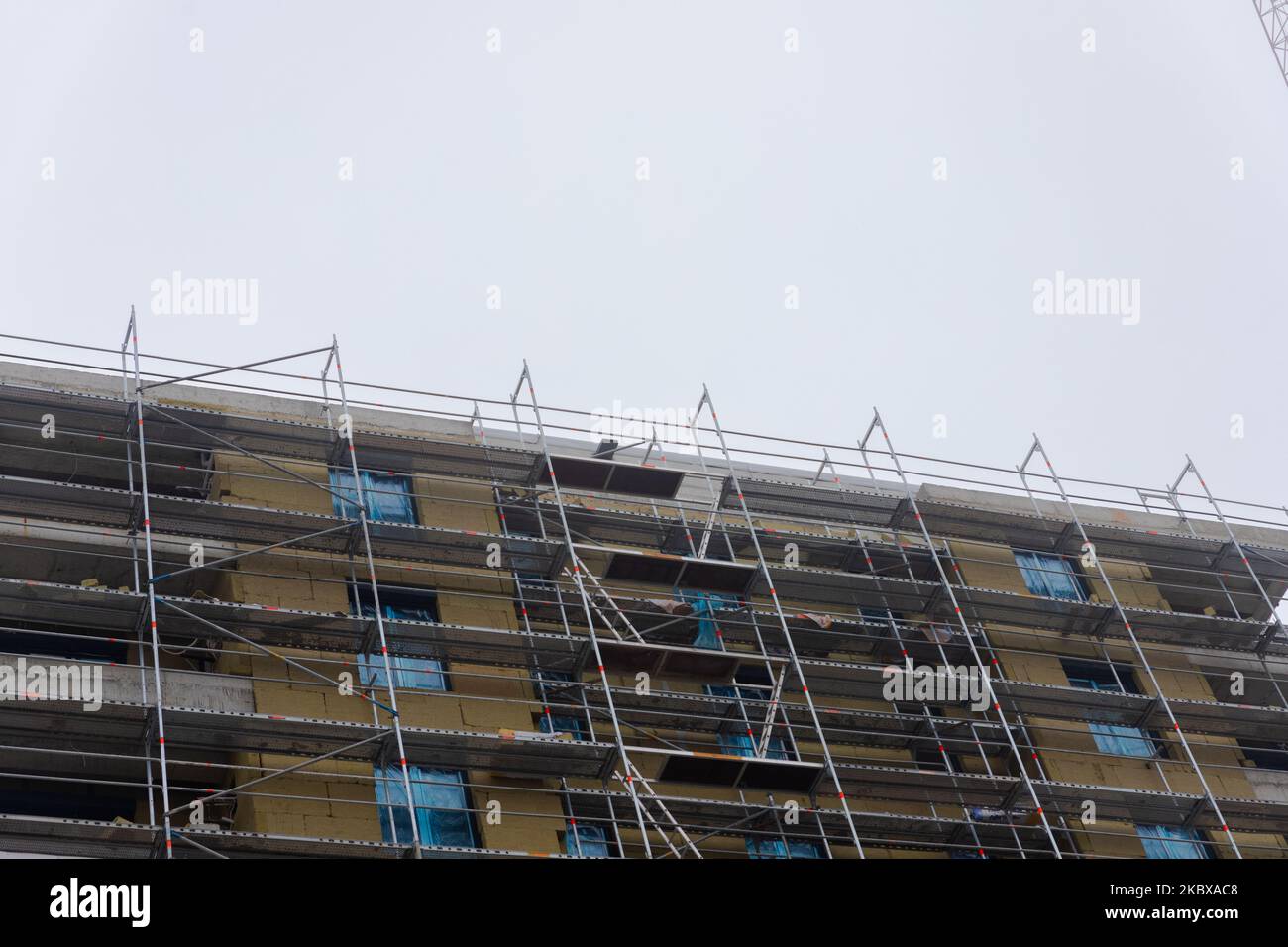 Building apartment building. Placing rock wool insulation on the walls ...