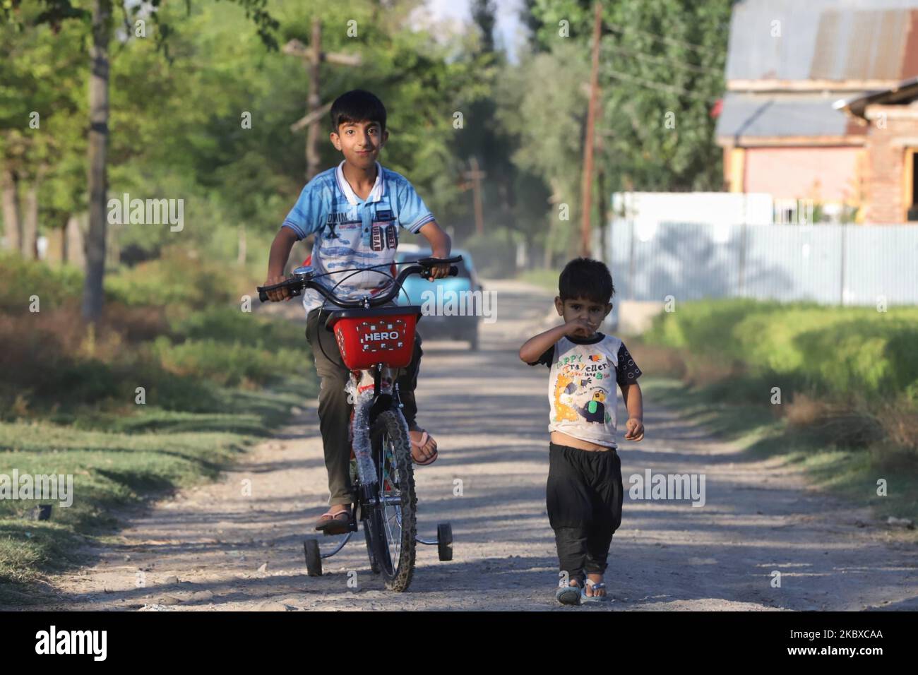 A Boy rides a New Bicycle in the outskirts of Sopore town of District Baramulla, Jammu and Kashmir, India on 21 August 2020, some 55 Kms from Srinagar city, the summer capital of Indian-controlled Kashmir (Photo by Nasir Kachroo/NurPhoto) Stock Photo