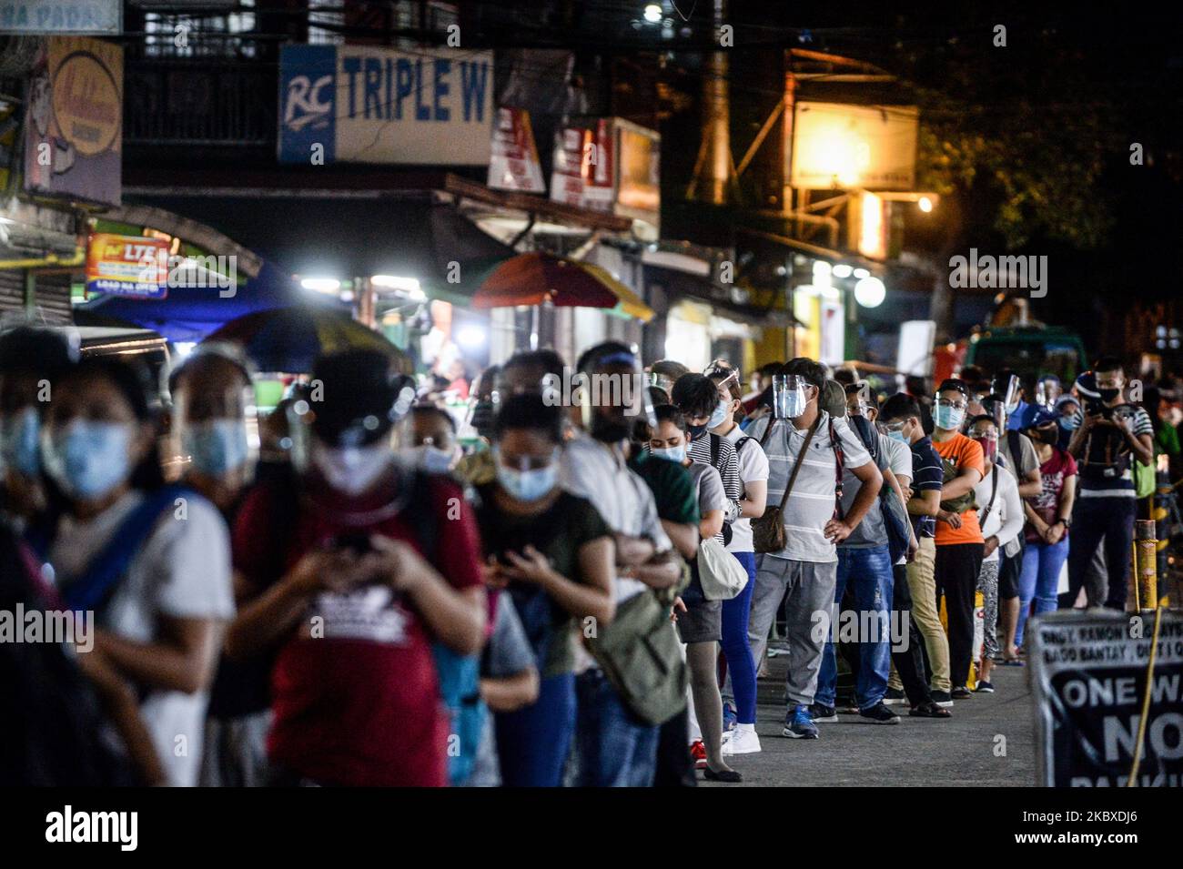 passengers wearing face masks and face shields queue at a bus terminal in quezon city philippines on august 22 2020 the total number of covid 19 cases in the philippines rose to 187249 after 4933 new cases have been recordedphoto by lisa marie davidnurphoto 2KBXDJ6