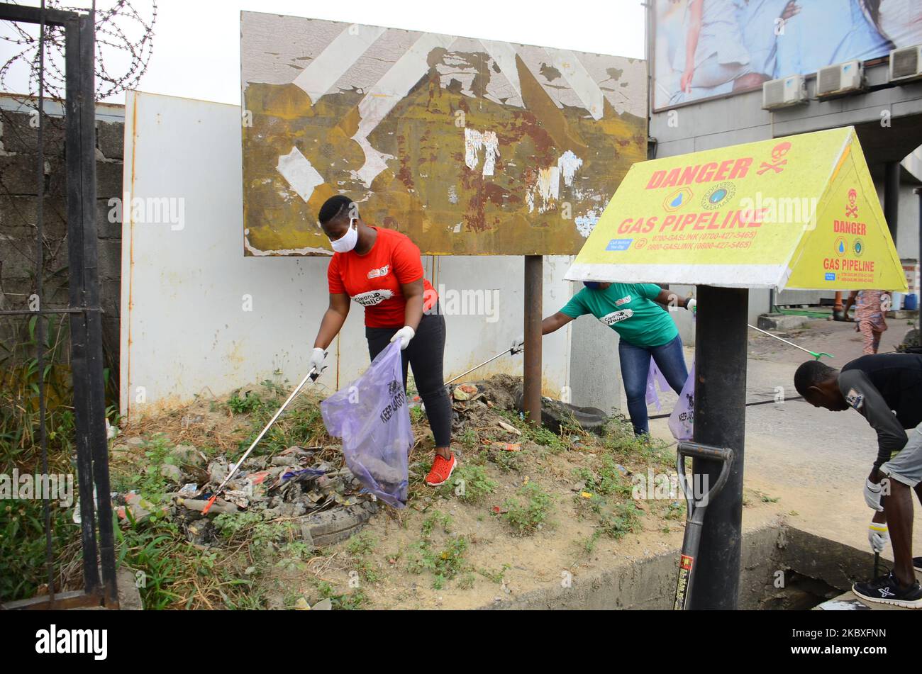 Groups of volunteers picking waste on the road sides and drainages in Lagos, Nigeria on August 23, 2020. A non-governmental organization African Clean-Up Initiative (ACI) partnered with NGOâ€™s and volunteers to clean up motor parks in Town Planning Way, Oshodi under bridge, Anthony and Ilupeju and also clean up 13 streets along Ilupeju, Oshodi area. A global social action program aimed at combating the global solid waste problem, in preparation toward expected rainfall and flood in Nigeria. (Photo by Olukayode Jaiyeola/NurPhoto) Stock Photo