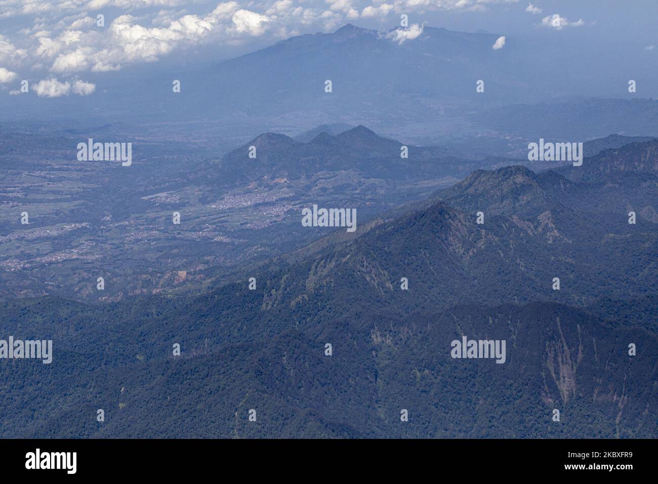 View of Mountail from an air plane in the sky at Java Island, Indonesia, on August 24, 2020. Indonesia have of total 139 active volcano the third largest country that have active volcano mountain. In Java Island there are 19 active volcano, one of them is Merapi Mountain at Yogyakarta that erupted in 2020. Beside of Pandemi situation that hit the country, Indonesia also facing the huge allert of disaster if all the active volcano erupted. (Photo by Donal Husni/NurPhoto) Stock Photo