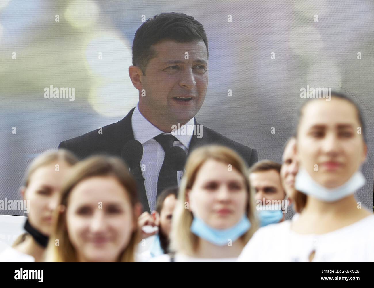 Ukrainian President Volodymyr Zelensky speaks (on a screen) during a ...