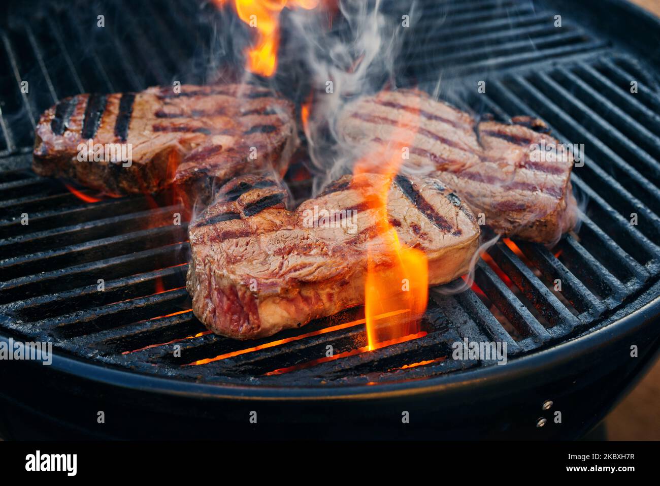 Barbecue dry aged angus ribeye beef steak grilled as closeup on a