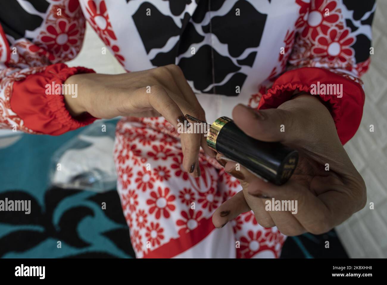 Doctor NINA AGUSTIN put on her nail paint in Malang, West Java ...