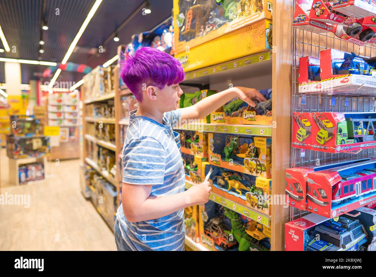 Lviv, Ukraine - May 7, 2022 : Toy's House interior, the biggest toy store. Teenage boy choosing birthday gift at toy market. Selective focus Stock Photo