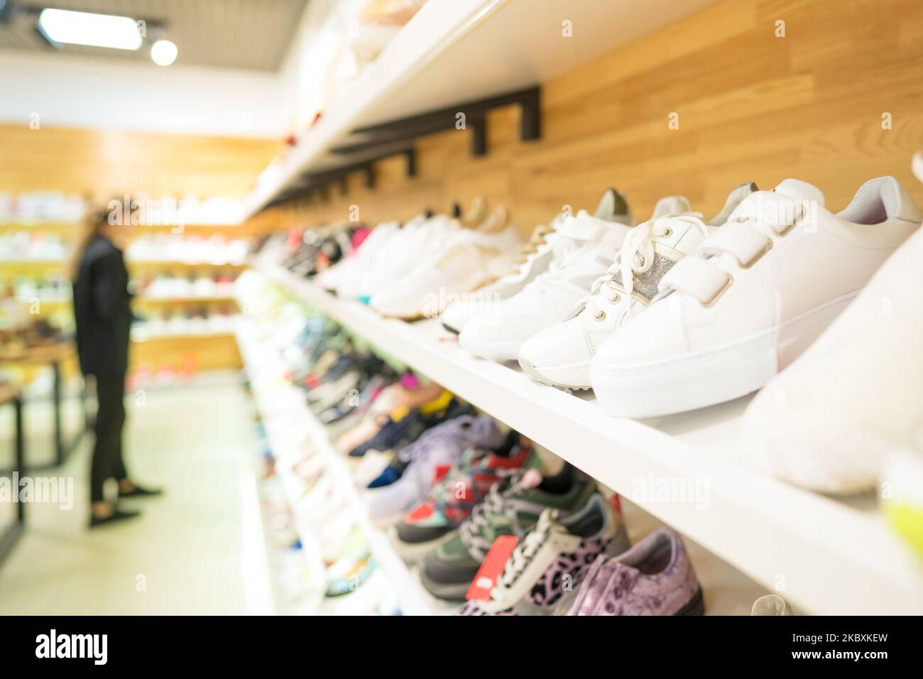 Shelves with many different footwear at shoes store thrift shopping