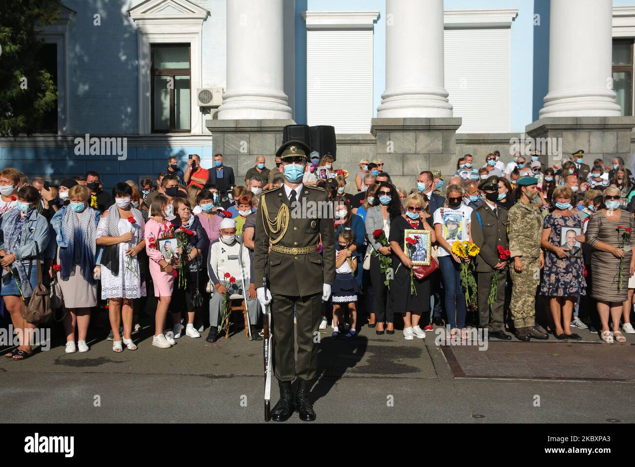 Honor Guard soldier stand next to fallen heroes families during the ...