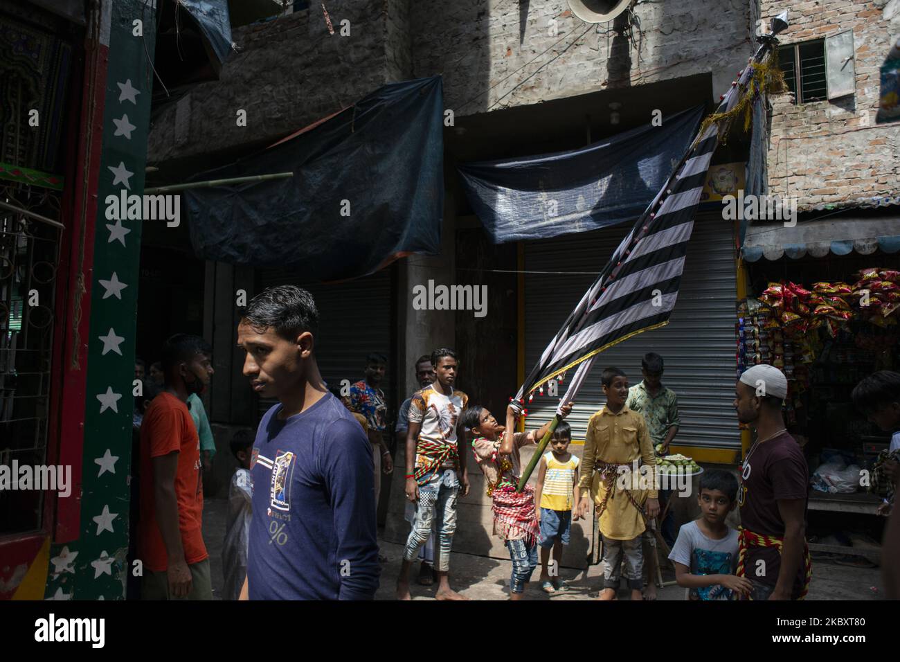 A child practicing to perform with the traditional flag in procession
