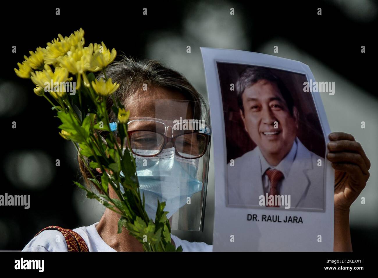 A woman holding an image of a doctor who died in time of COVID-19 joins a protest in commemoration of National Heroes Day in Quezon City, Metro Manila, Philippines on August 31, 2020.(Photo by Lisa Marie David/NurPhoto) Stock Photo