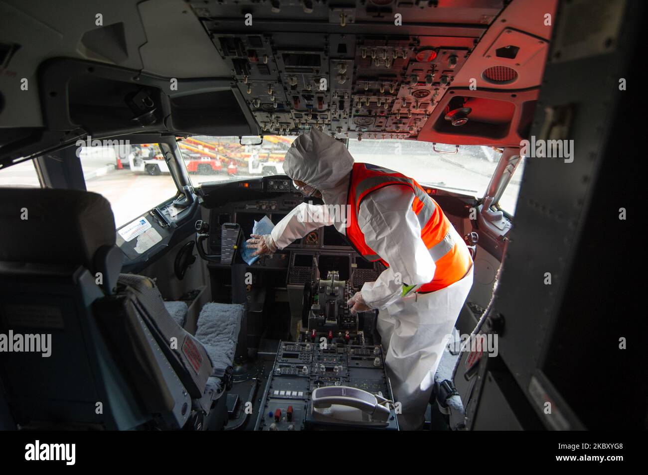 A worker with a biohazard suit disinfects and cleans the cockpit of the planes before boarding to prevent the spread of Novel Coronavirus at el Dorado Airport after five months of inactivity El Dorado International Airport prepares with biosecurity measures to prevent the spread of the Novel Coronavirus to resume activities on september first with 14 diferent domesitc routes in Bogota, Colombia on August 31, 2020. (Photo by Sebastian Barros/NurPhoto) Stock Photo