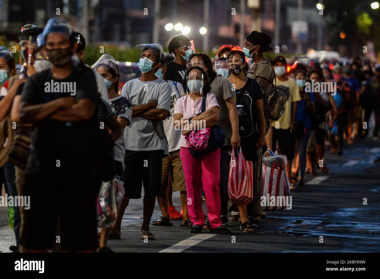 People queue as they wait for buses in Manila, Philippines on September