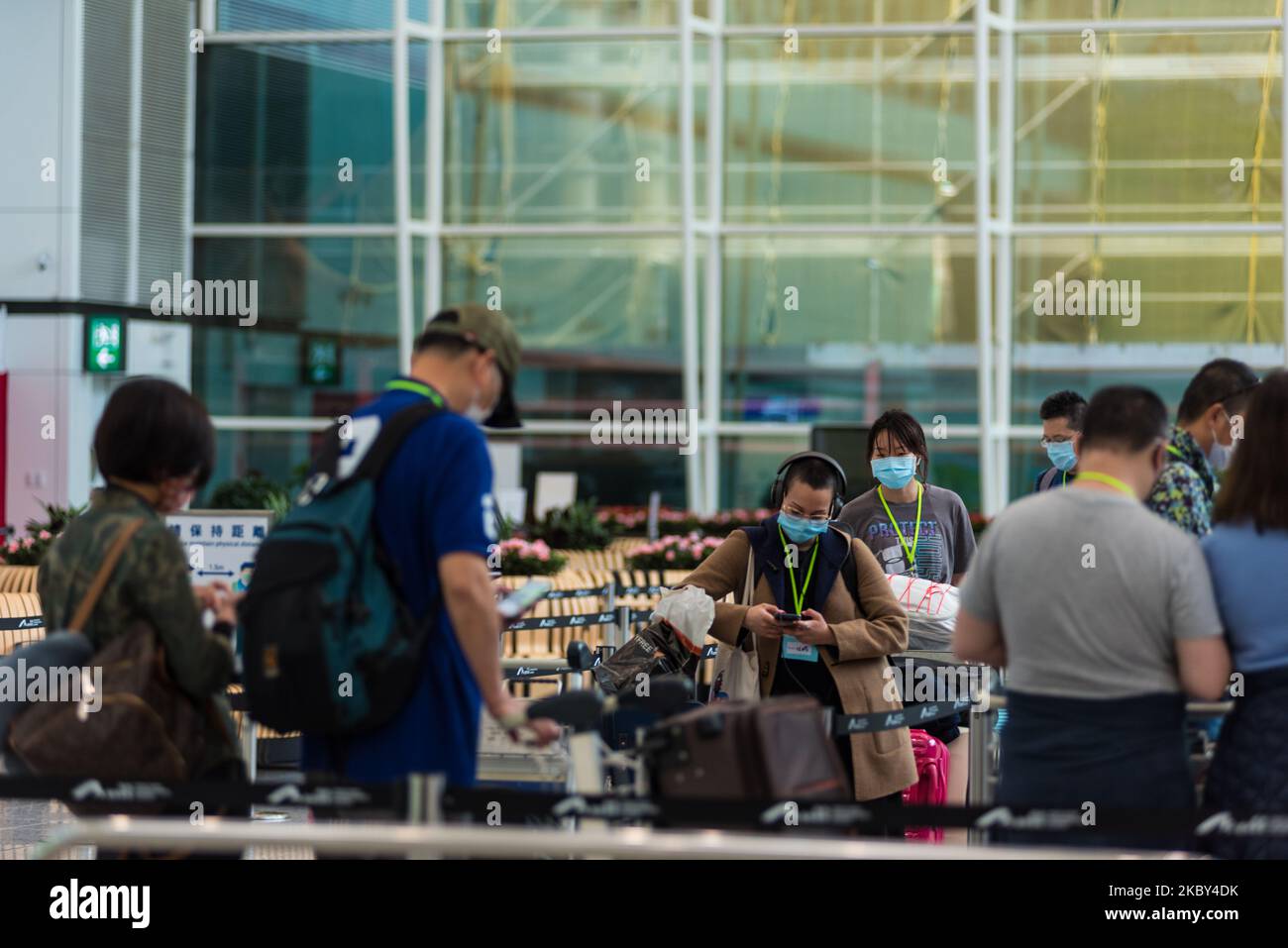 People having to take a bus to their designated quarantine hotel wait