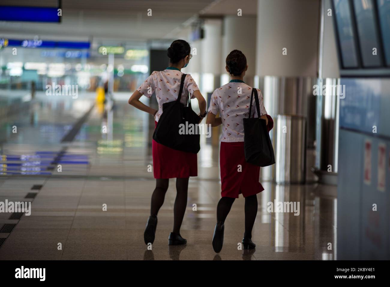 Two Cathay Pacific crew walk through the Hong Kong International