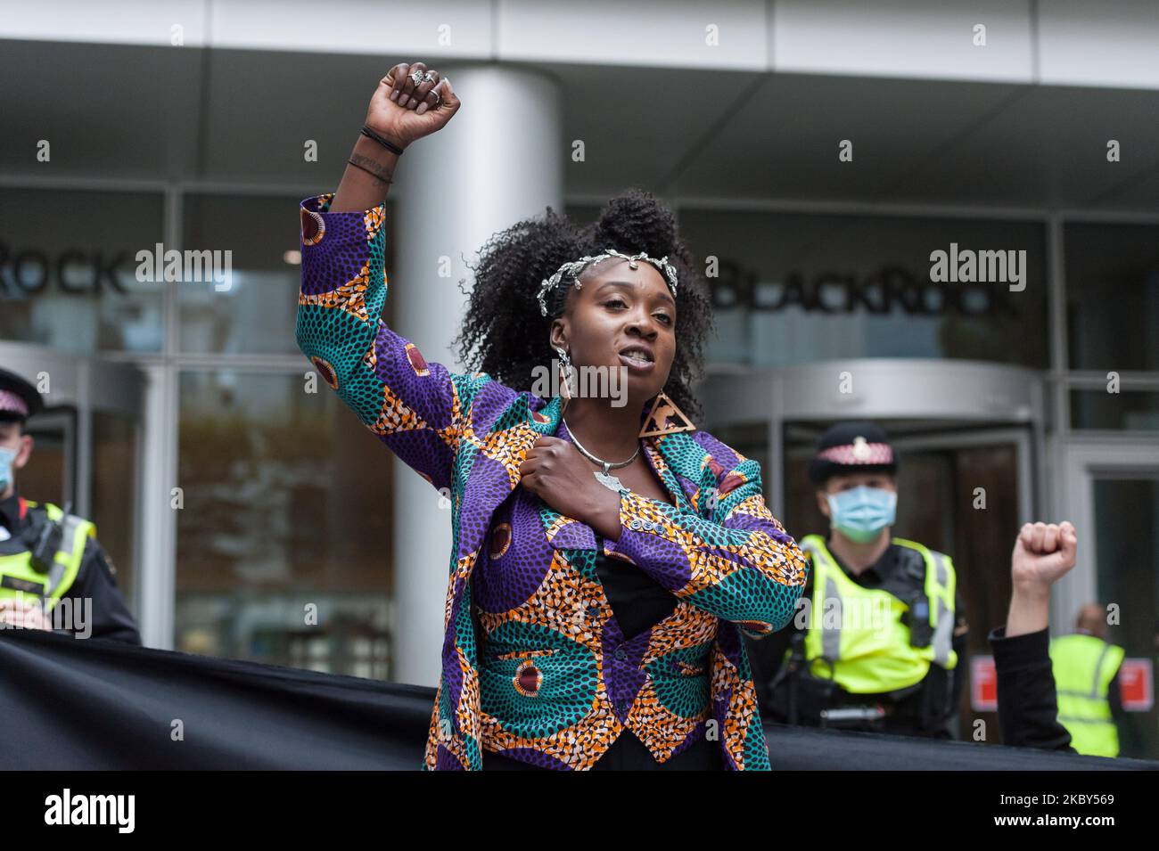 Activist Marvina Newton makes a raised fist gesture outside the headquarters of BlackRock investment company during Extinction Rebellion march through the City of London to protest against the companies and institutions that profited from the slave trade or are financing and insuring major fossil fuel projects and extraction of resources, particularly in the developing countries of the Global South, on 04 September, 2020 in London, England. Protesters demand reparations for communities affected by colonial and neo-colonial exploitation. (Photo by WIktor Szymanowicz/NurPhoto) Stock Photo