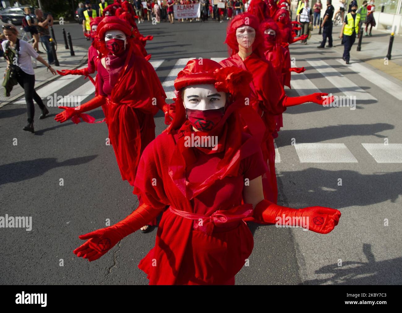 Extinction rebellion activists perform as Red Rebel Brigade during a march gainst climate change on September 5, 2020 in Warsaw, Poland. A few thousand people took the streets in the great march for climate organised by Extinction Rebellion as the start of the climate protests season to demand immediate action from the politics and to raise awareness about climate changes. (Photo by Aleksander Kalka/NurPhoto) Stock Photo