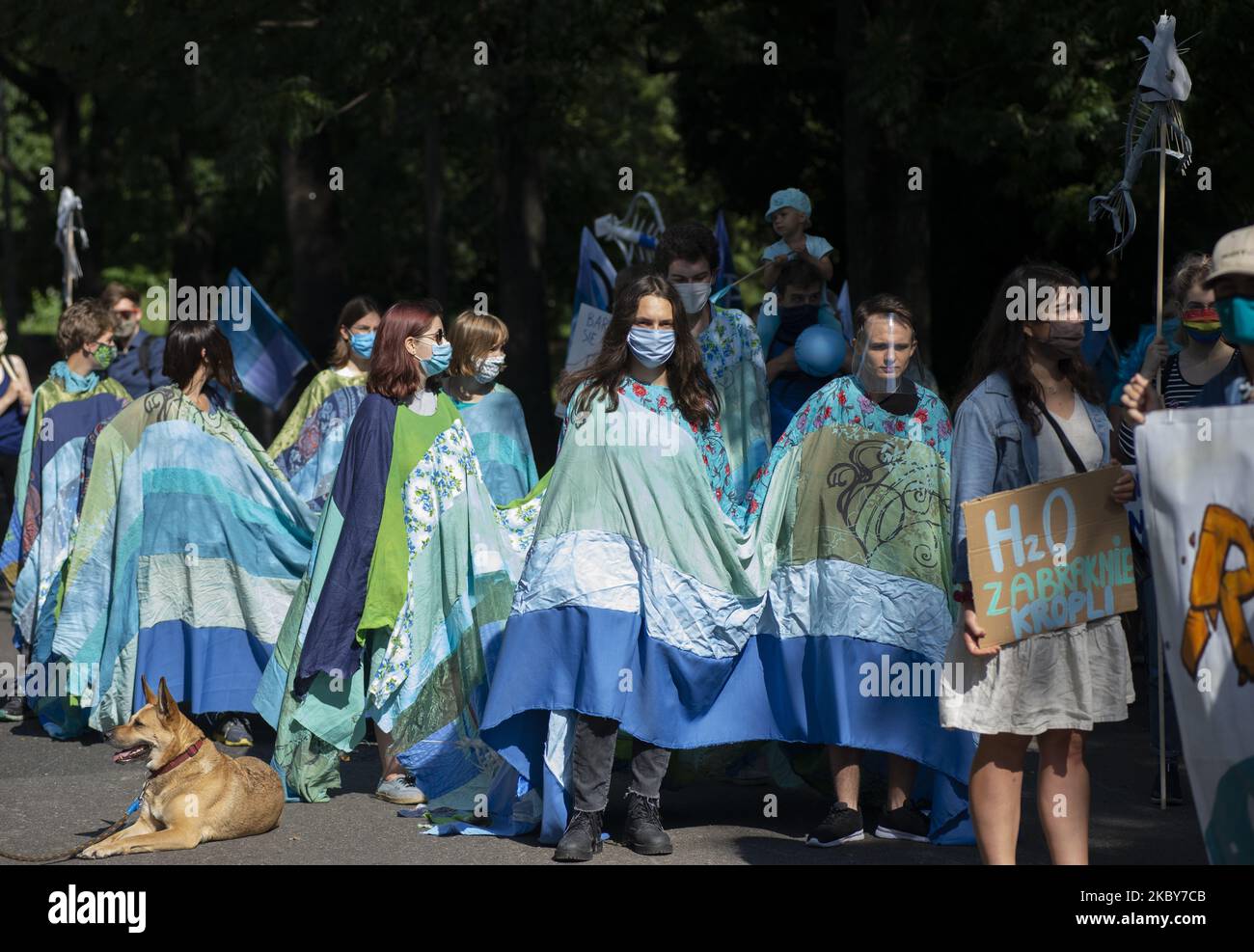 Demonstrators wear a fabric that illustrates a wave during the great march for climate on September 5, 2020 in Warsaw, Poland. A few thousand people took the streets in the great march for climate organised by Extinction Rebellion as the start of the climate protests season to demand immediate action from the politics and to raise awareness about climate changes. (Photo by Aleksander Kalka/NurPhoto) Stock Photo