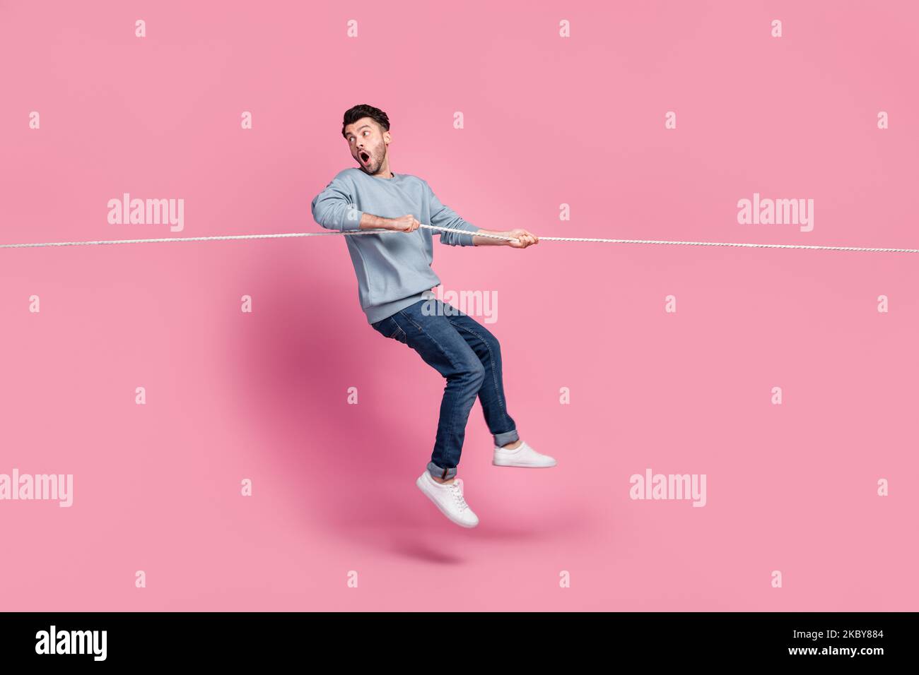 Profile side full length photo of guy jump pulling string look back ...