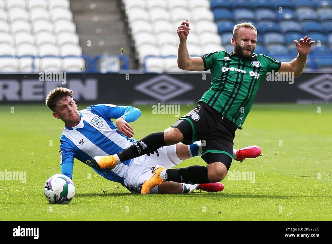 Huddersfield Towns Ben Jackson (left) tackles Rochdale's Stephen Dooley