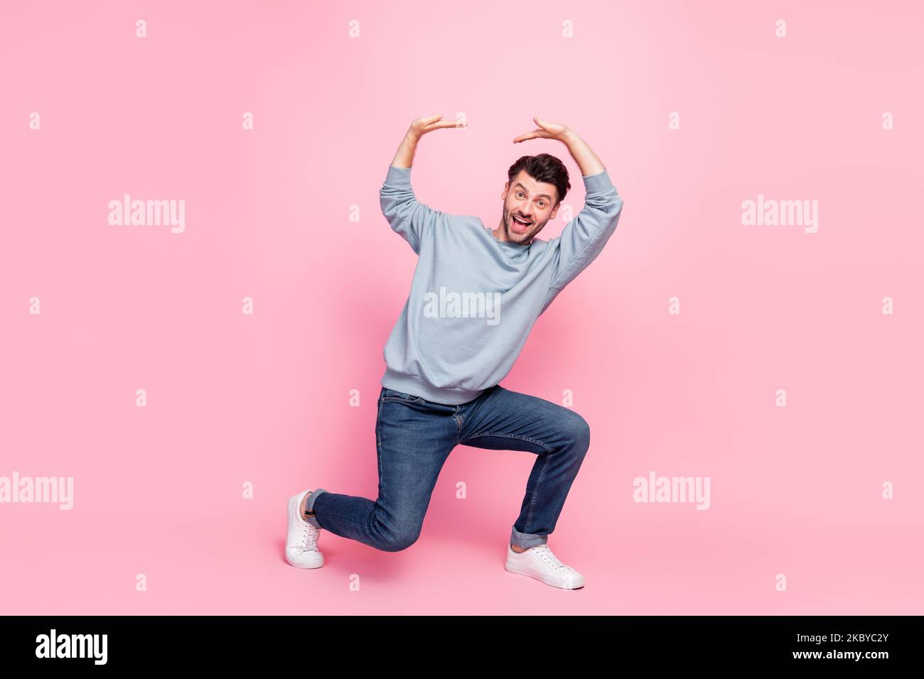 Full length photo of attractive young man strong hold heavy empty space ...