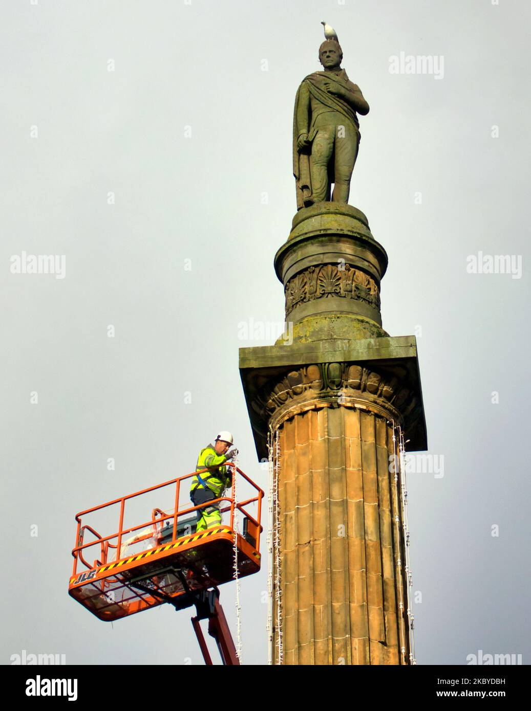 Glasgow, Scotland, UK 4th November, 2022.  Work begins on Christmas lights in the city centre George square as council workers se a platform reach the heights of the sir Walter Scott statue . Credit Gerard Ferry/Alamy Live News Stock Photo