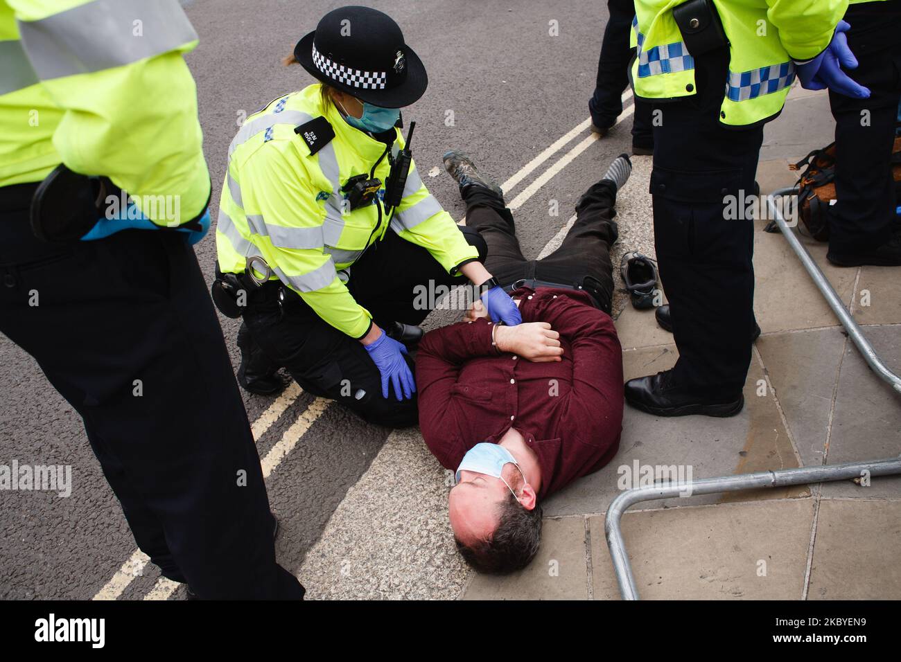Police officers surround an arrested and handcuffed member of climate change activist movement Extinction Rebellion in Parliament Square in London, England, on September 9, 2020. The group resumed protests in the city last Monday, staging demonstrations most days since, after a hiatus in its actions during the height of the coronavirus crisis. (Photo by David Cliff/NurPhoto) Stock Photo