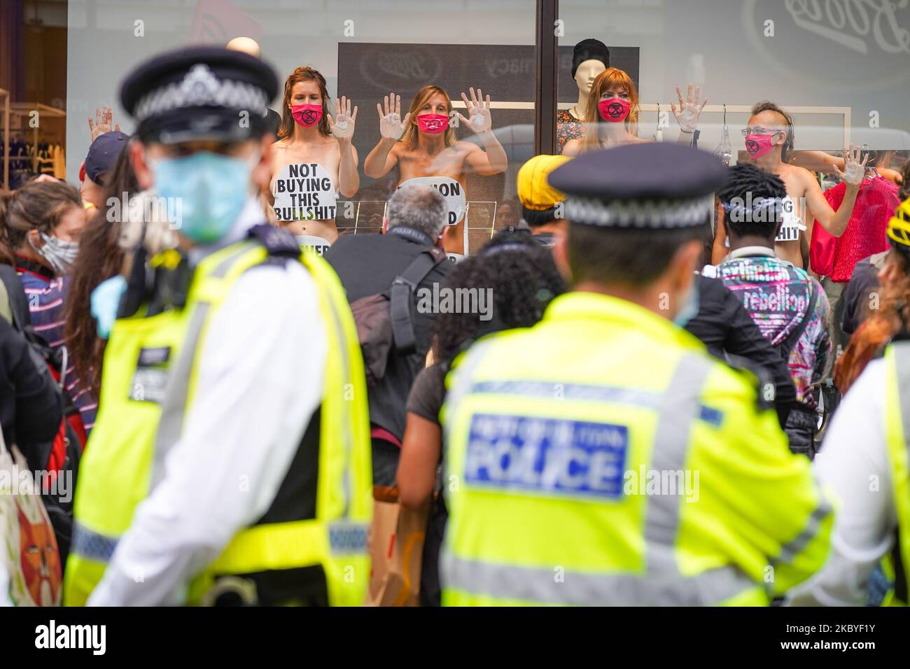 Members of the Extinction Rebellion environmental campaign group stage a protest inside a shop window to protest against fashion industry in H&M at Oxford Street in central London 9 September 2020 (Photo by Giannis Alexopoulos/NurPhoto) Stock Photo