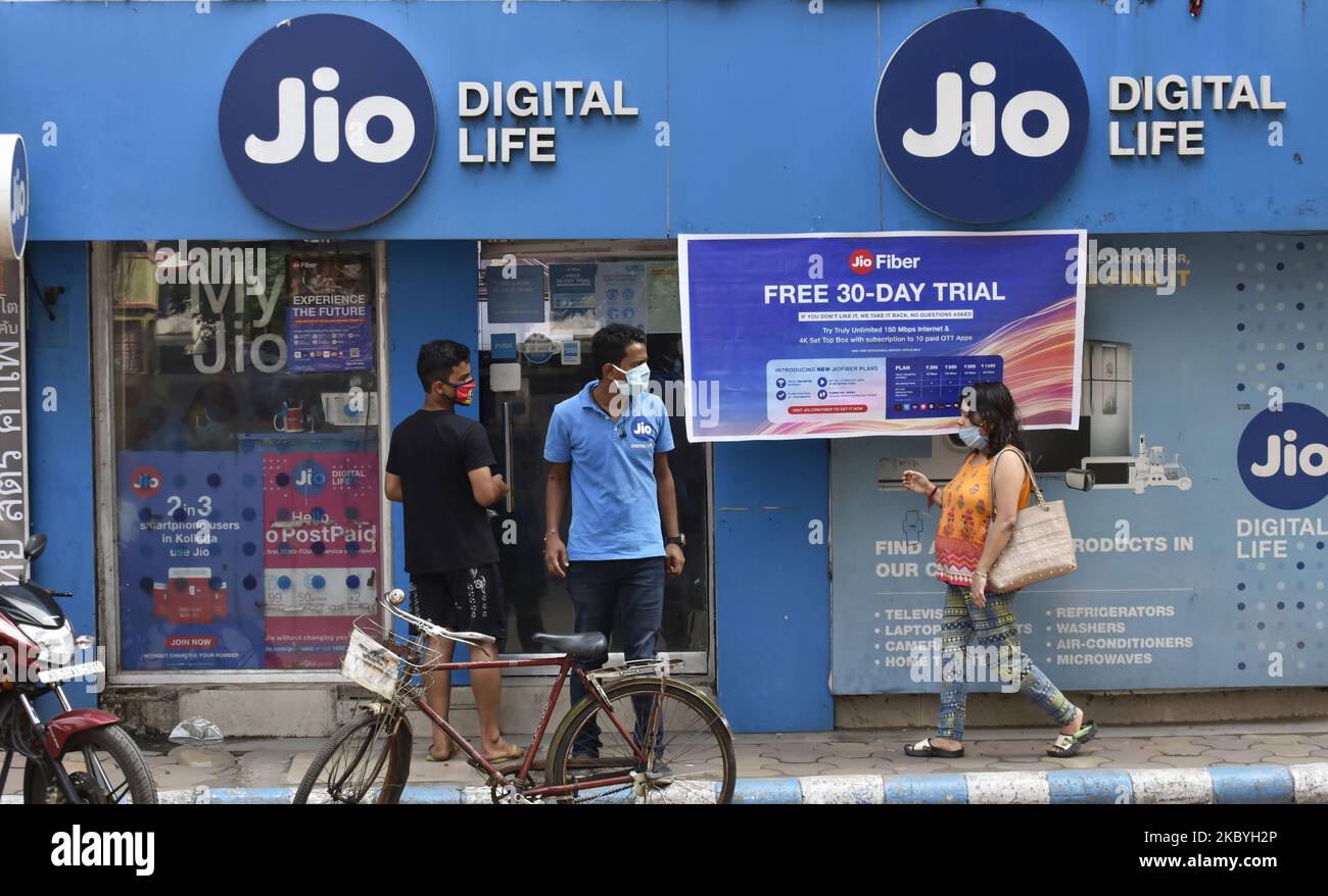 A woman walks past a Jio store in Kolkata, India, 10 September, 2020