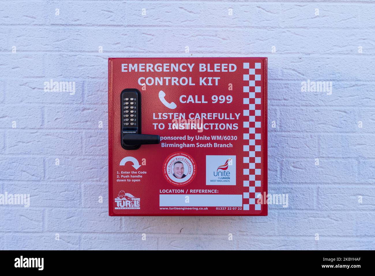 Emergency bleed control kit in red box mounted on a wall in Kings Heath High Street, Birmingham Stock Photo