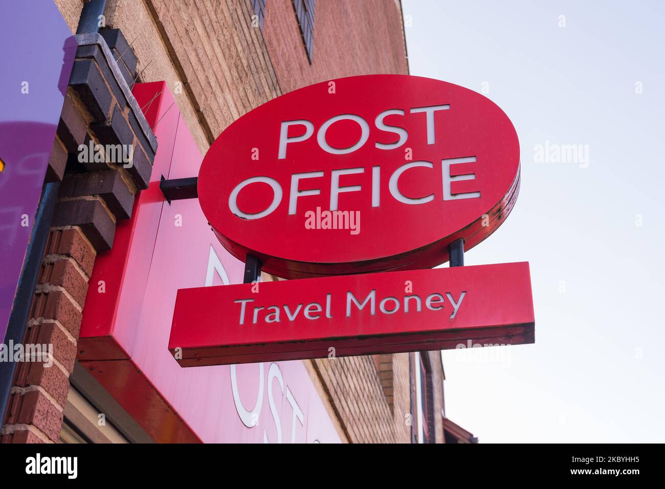 Red Post Office sign advertising travel money Stock Photo