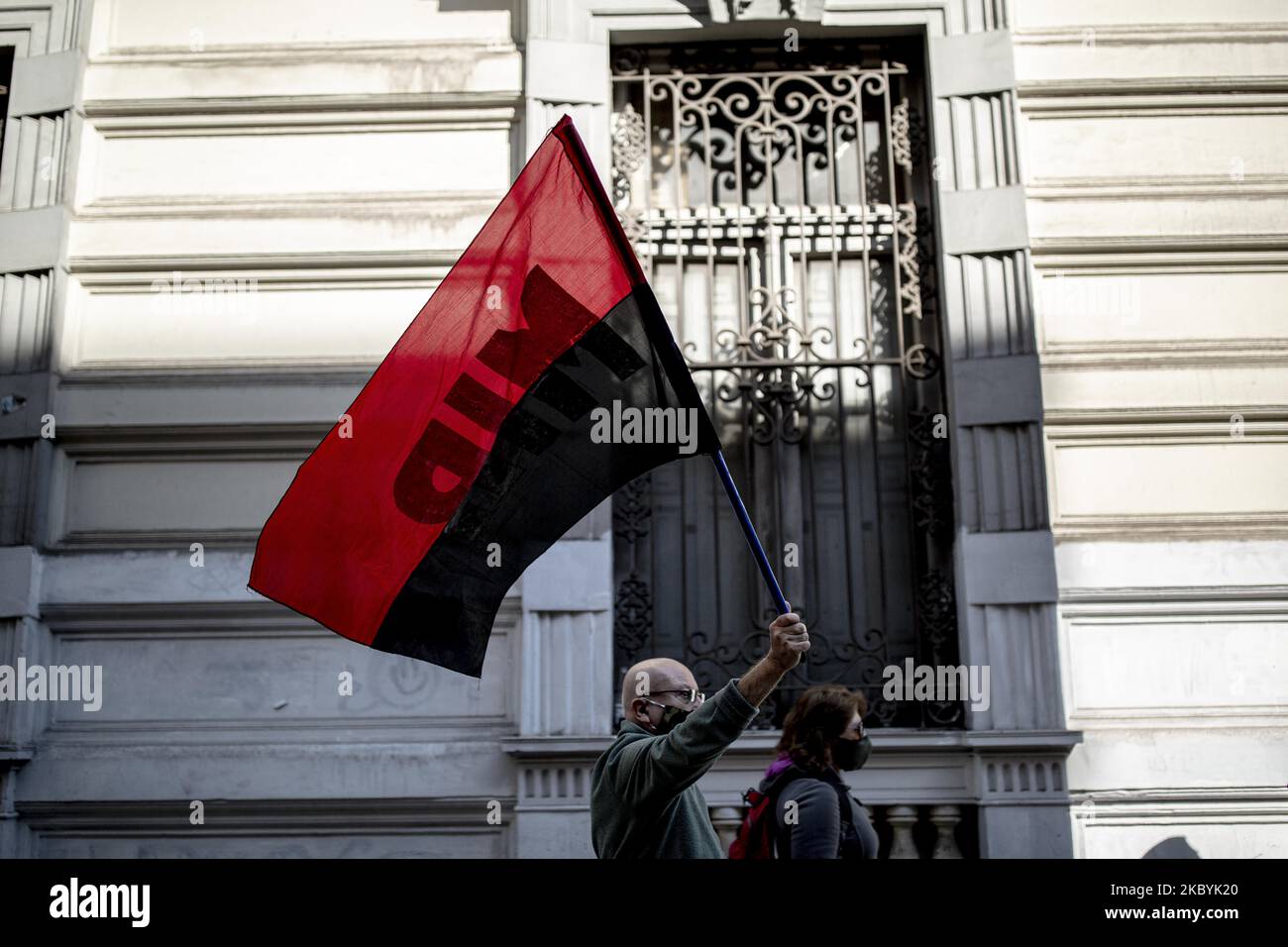 A demonstrator holds a flag during a protest on the 47th anniversary of the last military coup that ousted President Salvador Allende on September 11, 2020 in Santiago, Chile. The military coup led by General Augusto Pinochet in 1973 imposed a dictatorship that lasted until 1990. (Photo by Felipe Vargas Figueroa/NurPhoto) Stock Photo