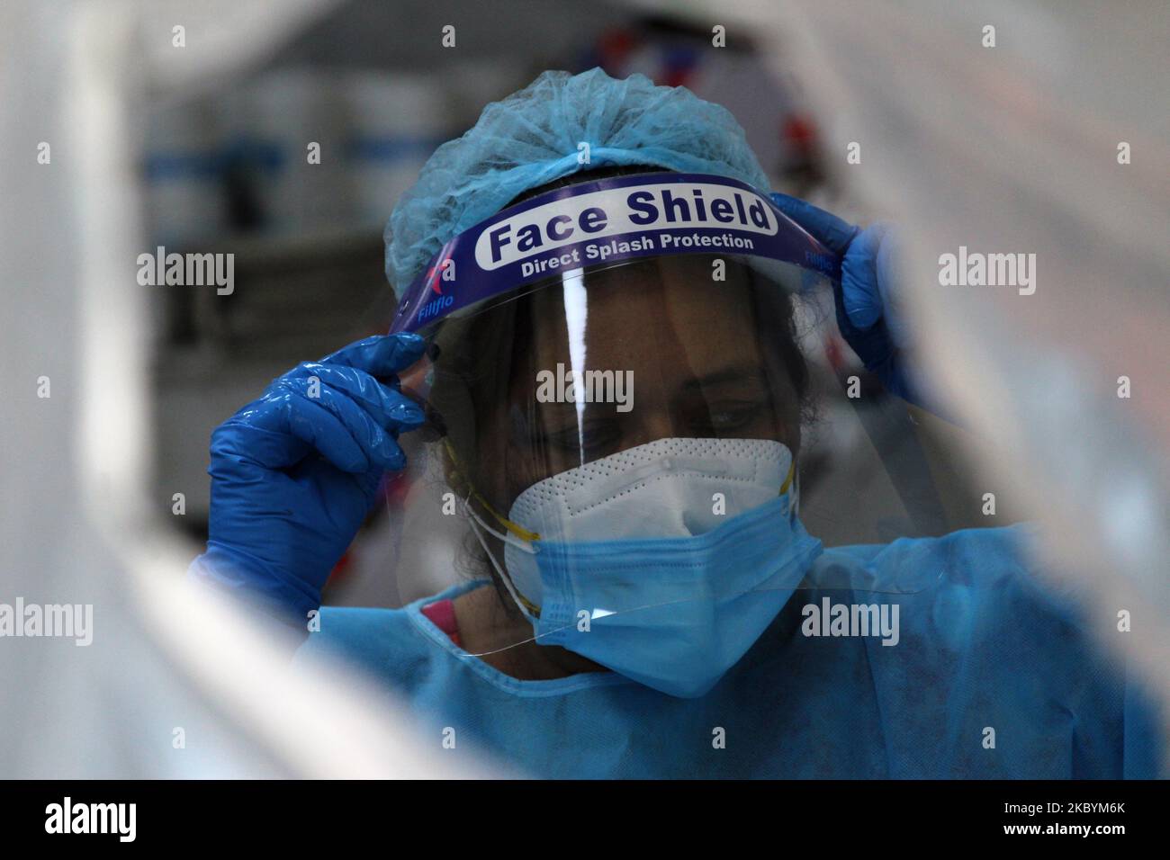 A health worker covered in Personal Protective equipment during nasal swab sample collection from a patient for corona virus Rapid Antigen Testing (RAT), at Nehru Homoeopathic Medical College and Hospital, Defence Colony on September 12, 2020 in New Delhi. With the highest single-day spike of 97,570 new cases and 1,201 deaths reported in the last 24 hours, India's Covid-19 count crossed the 46-lakh mark today. According to the health ministry, the Covid-19 case tally stands at 46,59,984 in the country. (Photo by Mayank Makhija/NurPhoto) Stock Photo