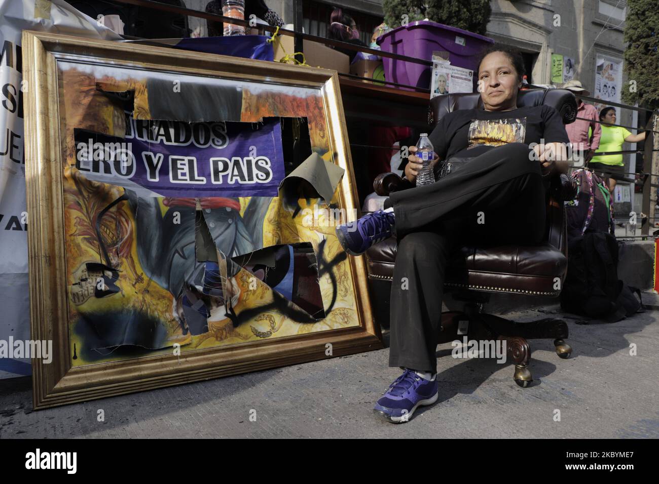 Yesenia Zamudio, mother of a victim of feminicide, sits next to the work of Miguel Hidalgo y Costilla, hero of the Independence of Mexico, which was destroyed with hammer blows, whose painting is by the Sinaloan painter Jomanu Art. On September 11, 2020 in Mexico City, Mexico. (Photo by Gerardo Vieyra/NurPhoto) Stock Photo