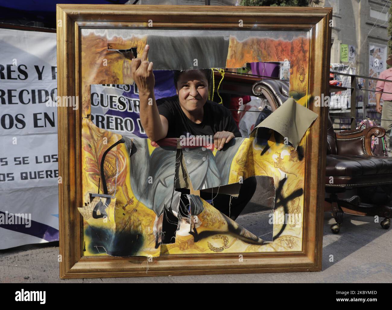 Yesenia Zamudio, mother of a victim of femicide, poses in the painting of Miguel Hidalgo y Costilla, hero of the Independence of Mexico, which was destroyed with hammer blows, whose work is by the Sinaloan painter Jomanu Art. On September 11, 2020 in Mexico City, Mexico. (Photo by Gerardo Vieyra/NurPhoto) Stock Photo
