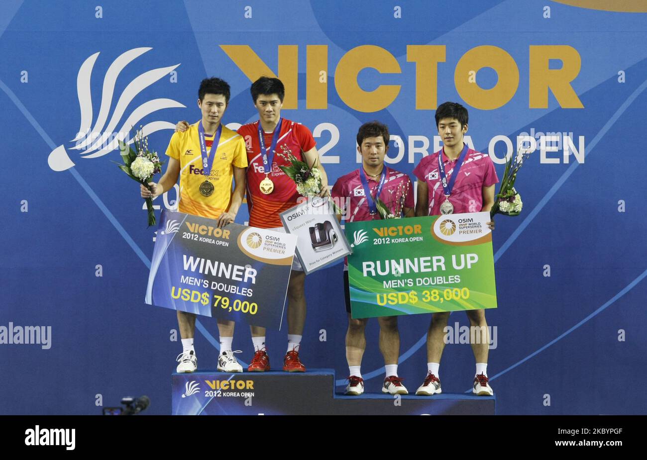 (from left) China's Cai Yun, Fu Haifeng and South Korea's Jung Jae Sung, Lee Yong Dae award ceremony on the podium after match in the man double final match at the Korea Open Badminton Super Series Premier in Olympic Park in Seoul, South Korea on 8 January 2012. China defeated South Korea 18-21, 21-17, 21-19. (Photo by Seung-il Ryu/NurPhoto) Stock Photo