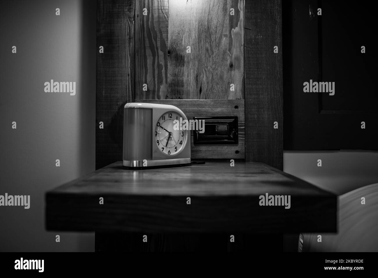 A vintage alarm clock in a hotel room in St. Paul in grayscale Stock
