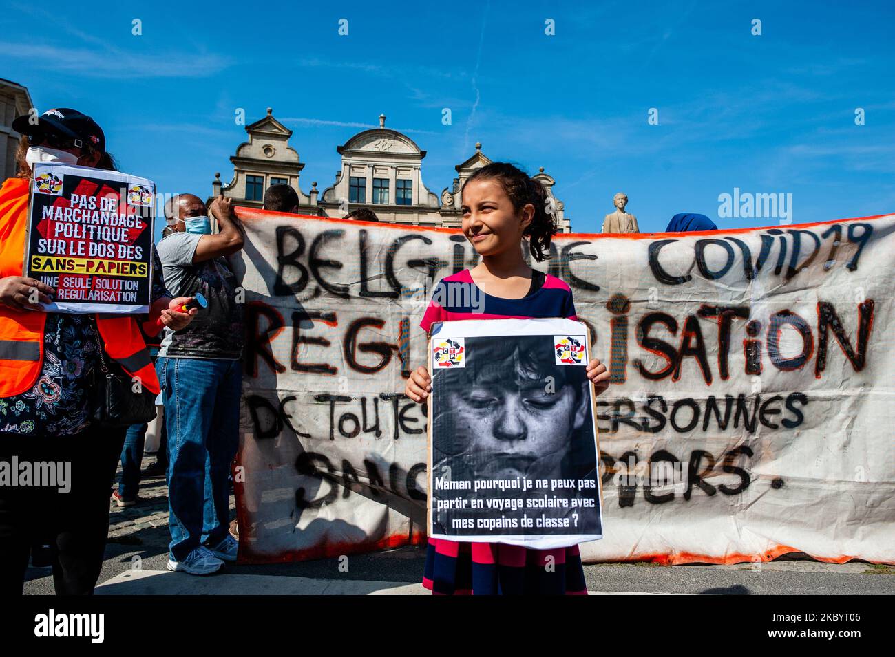 An immigrant child is posing while holding a pro refugees placard, during the Belgian health care staff demonstration, that has taken place in Brussels, Belgium on September 13th, 2020. (Photo by Romy Arroyo Fernandez/NurPhoto) Stock Photo