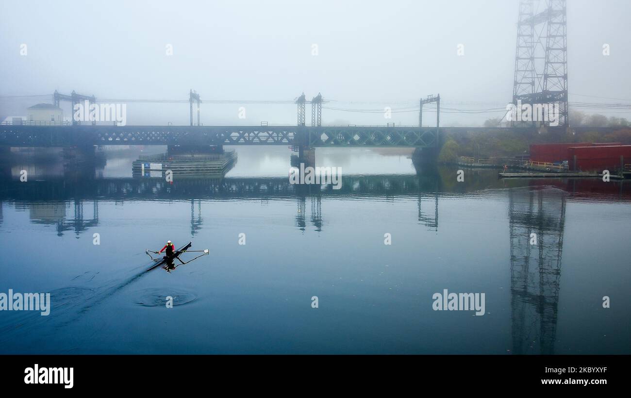 NORWALK, CT, USA - NOVEMBER 4, 2022: Beautiful fog in town with row boat and railroad bridge Stock Photo