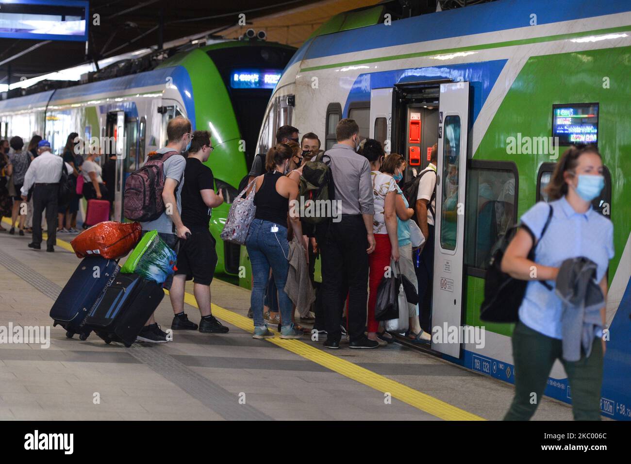 People getting on the train at the main station in Krakow. On September 15, 2020, in Krakow, Poland. (Photo by Artur Widak/NurPhoto) Stock Photo